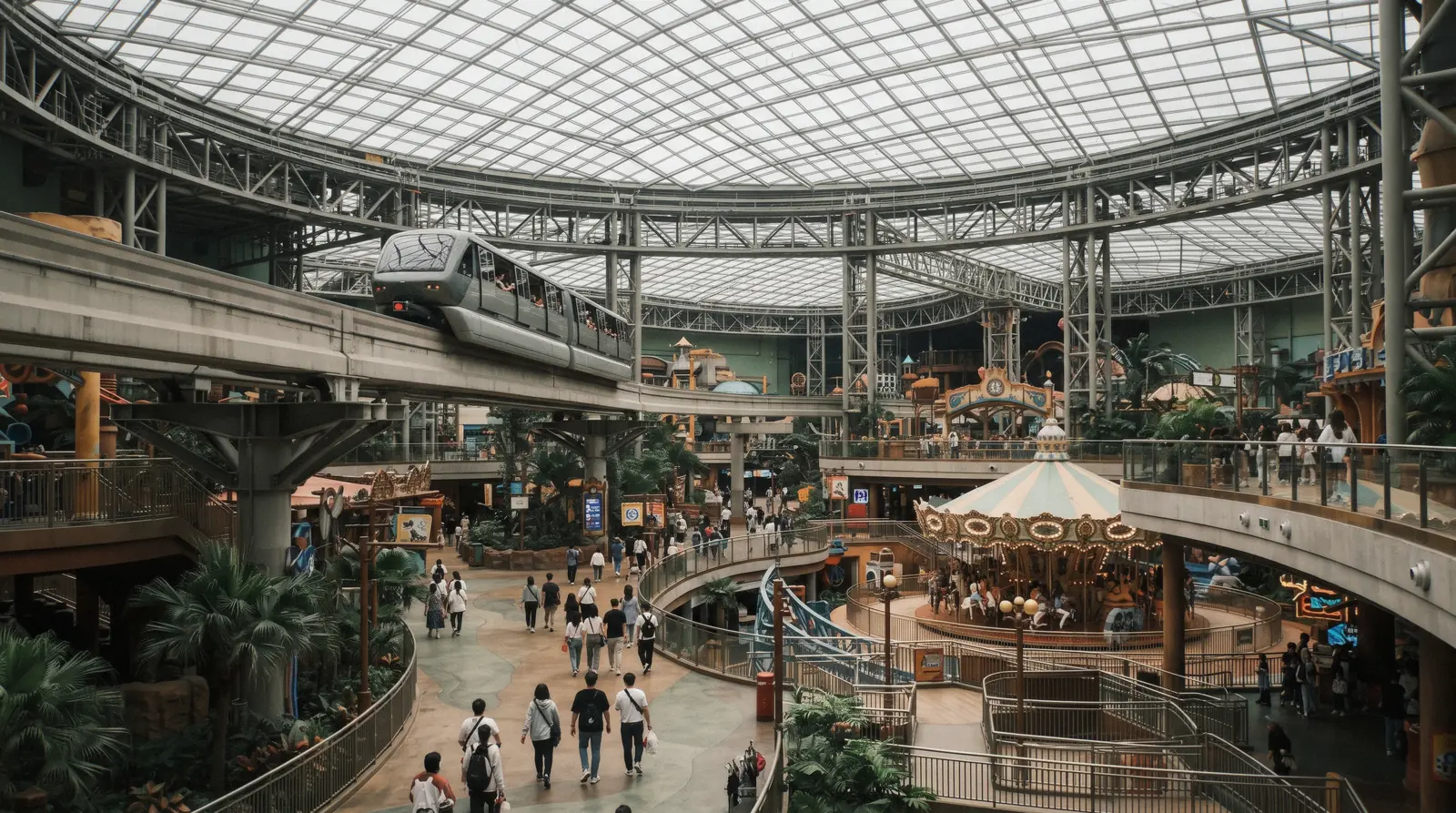 Rides and the monorail track under the glass roof of the indoor Lotte World theme park, Seoul, South Korea